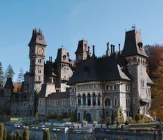 an old castle with many towers and windows on the top of it's roof