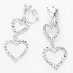 Keep up with the latest trend of earrings with no piercings necessary! These drop earrings feature two faux crystal embellished hearts hanging from each clip on heart post. Finish: Silver-tone Drop: 1.5" Closure: Clip on Material: Metal - Claire's Silver 1.5" Triple Heart Clip On Drop Earrings Silver Heart Earring, Valentines Dance, Claires Earrings, Claire's Accessories, Heart Clip, Triple Heart, Pretty Jewelry Necklaces, Woman Jewelry, Silver Heart Earrings