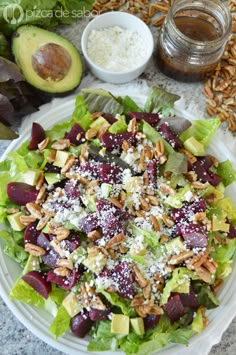 a salad on a plate with nuts and cheese