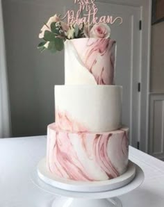 a three tiered cake decorated with pink marble