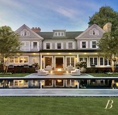 a large house with a pool in front of it