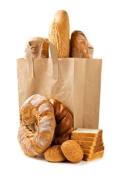 an assortment of breads and pastries in a paper bag on a white background