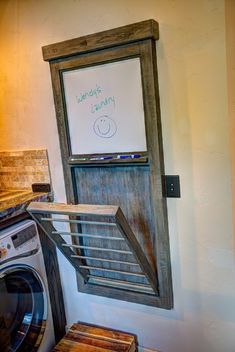 a washer and dryer in a small room with a sign on the door