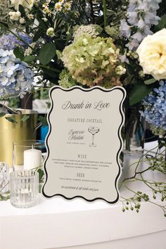 a table topped with lots of flowers and candles