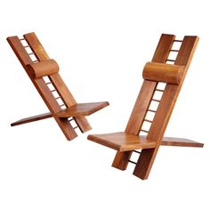 two wooden chairs sitting next to each other