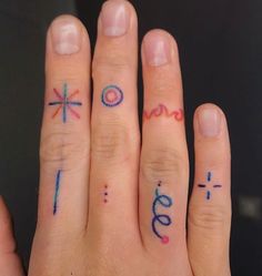 two people with tattoos on their fingers are holding each other's hands and one has the word love written on it