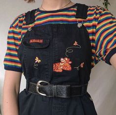 a woman wearing overalls and a striped shirt