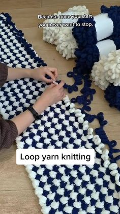 a woman is knitting on a blue and white rug with text overlay that reads loop yarn knitting