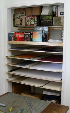 an open book shelf with many books on it in a room that is being used as a storage unit