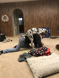 a man laying on the floor with his dog