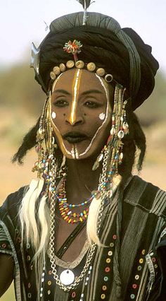 an african woman with long hair and beads