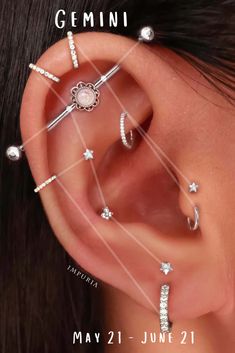 an ear with multiple piercings on it and the words gems in front of it