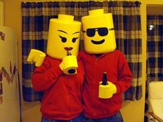 two people dressed in legos are drinking beer