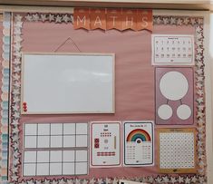 a pink bulletin board with lots of different items on it and a whiteboard attached to the wall