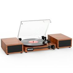 an old record player with its turntable and speakers on the side, in front of a white background