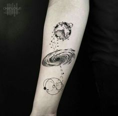 a person with a black and white tattoo on their arm that has an image of the planets