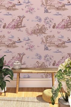 the wallpaper in this room is pink and has an image of disney characters on it