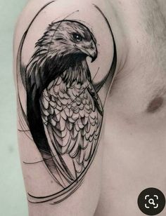 an eagle tattoo on the left arm and shoulder, with a circular frame around it