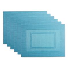 six blue placemats are lined up on top of each other, with one square in the middle