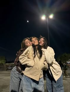 four girls standing together in front of a street light