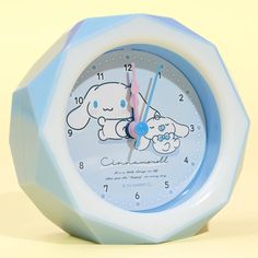 a blue and white clock with a cartoon dog on it