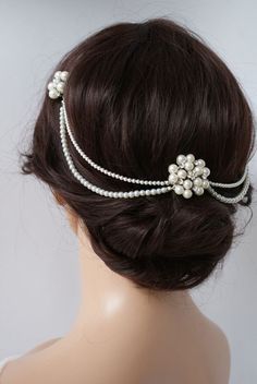 a woman wearing a hair comb with pearls on it