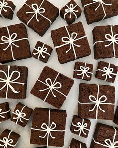 chocolate brownies with white icing and bows on them