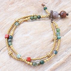 Pretty agate gems in varying shades of green mingle with shimmering brass on Tiraphan Hasub's pretty bracelet. The Thai artisan hand crafts the double-stranded bracelet from smooth brass beads red jasper cubes and green agate gems. She then finishes her creation with a button clasp fashioned from large agate beads and waxed polyester cord. Blessing Beads, Jasper Bead Bracelet, Hand Crafts, Brass Beads, Jewelry Making Necklace, Small Beads, Wrap Bracelets, Pretty Bracelets, Green Agate