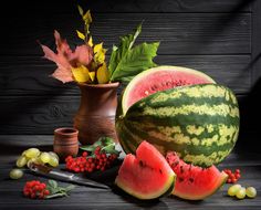 a watermelon and other fruits on a table