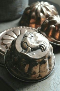 three metal cake pans sitting on top of a table