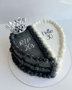 there is a cake decorated with black and white frosting