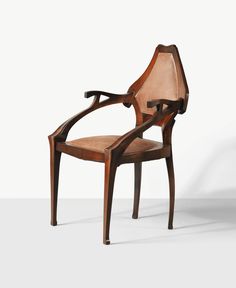 a chair that is made out of wood and has an arm rest on the back