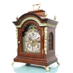 an antique wooden clock with roman numerals