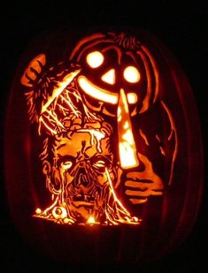 a carved pumpkin with an image of a man holding a knife in it's mouth