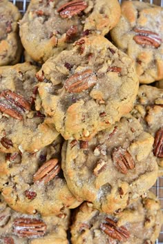 a pile of pecan cookies sitting on top of a cooling rack