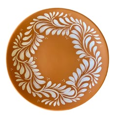 an orange plate with white designs on it