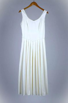 This is a stunning yet simple Laura Ashley wedding dress, made in Great Britain. It is 100% cotton, with a viscose/rayon lining. It has a side zipper. Measurements are as follows:     Size: UK 14, Euro 40, USA 10     Pit to pit, front: 18 1/2"     Pit to pit, back: 18"     Shoulder seam to hem: 49 1/2"     Scoop front to hem: 43"     Waist: 29 1/2"-30"     Scoop dip: 8" This was purchased in 1997, and it has all of the fine quality of that era of Laura Ashley. Simple and elegant. Laura Ashley Wedding, Laura Ashley Wedding Dress, Wedding Dress Ivory, Ivory Wedding Dress, Laura Ashley, Bridal Gowns, Bridal Dresses, Wedding Gowns, Art Collection