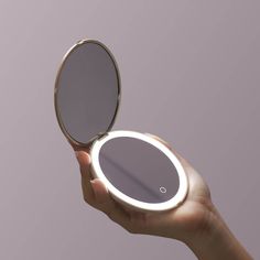 a person holding a mirror in their hand