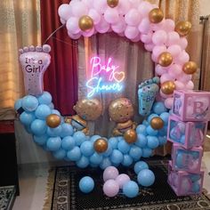 balloon arch with baby shower decorations and balloons