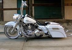 a white and black motorcycle parked on the street