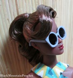 a close up of a doll wearing sunglasses