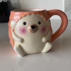 a ceramic bear mug sitting on top of a table