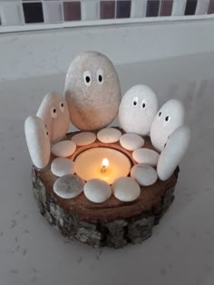 some rocks and candles are sitting on a table