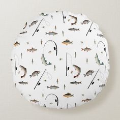 a white round pillow with fish and fishing rods on it, all over the surface