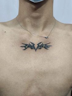 a man's chest with some birds on it