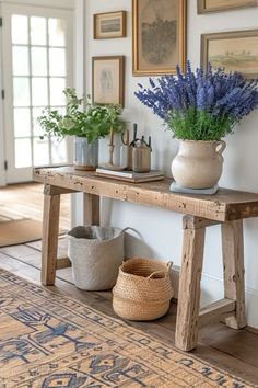 a wooden table with vases and flowers on it