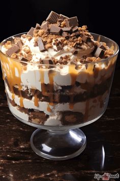 an ice cream sundae with chocolate and caramel toppings on top, in a glass dish