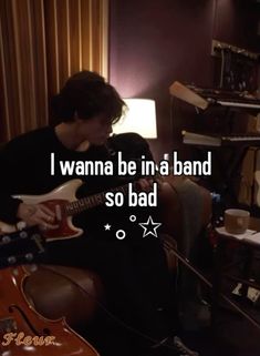 a person sitting in a chair with a guitar and text that reads i wanna be in a band so bad