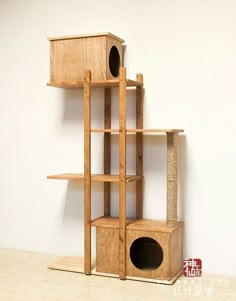 a wooden cat tree with two cats in it