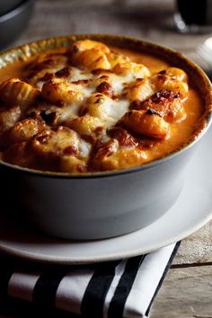 a white bowl filled with food on top of a plate